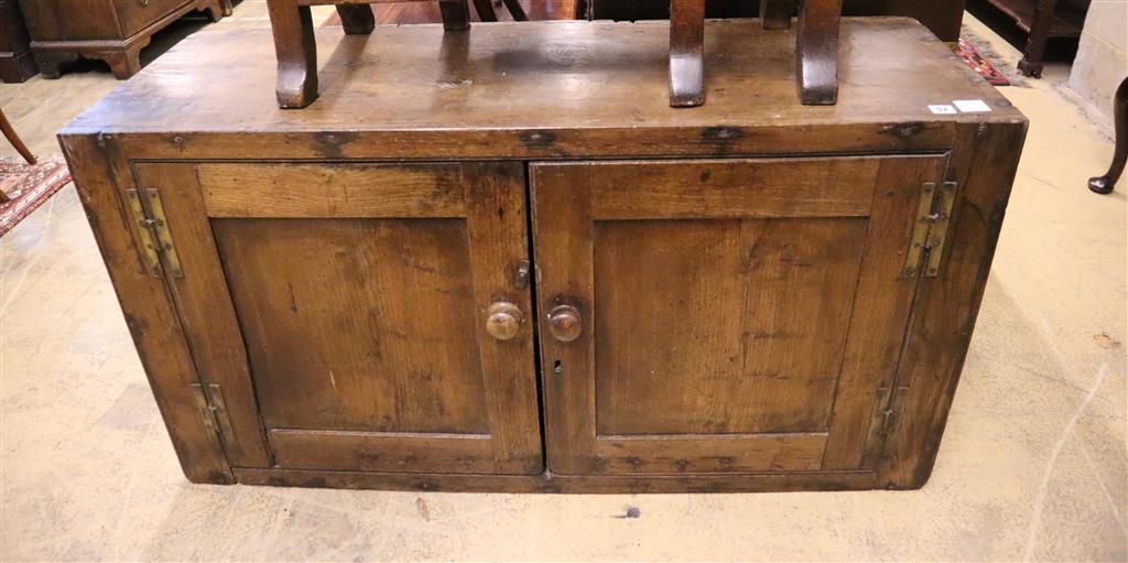 An 18th century oak two door cabinet, width 132cm, depth 44cm, height 71cm